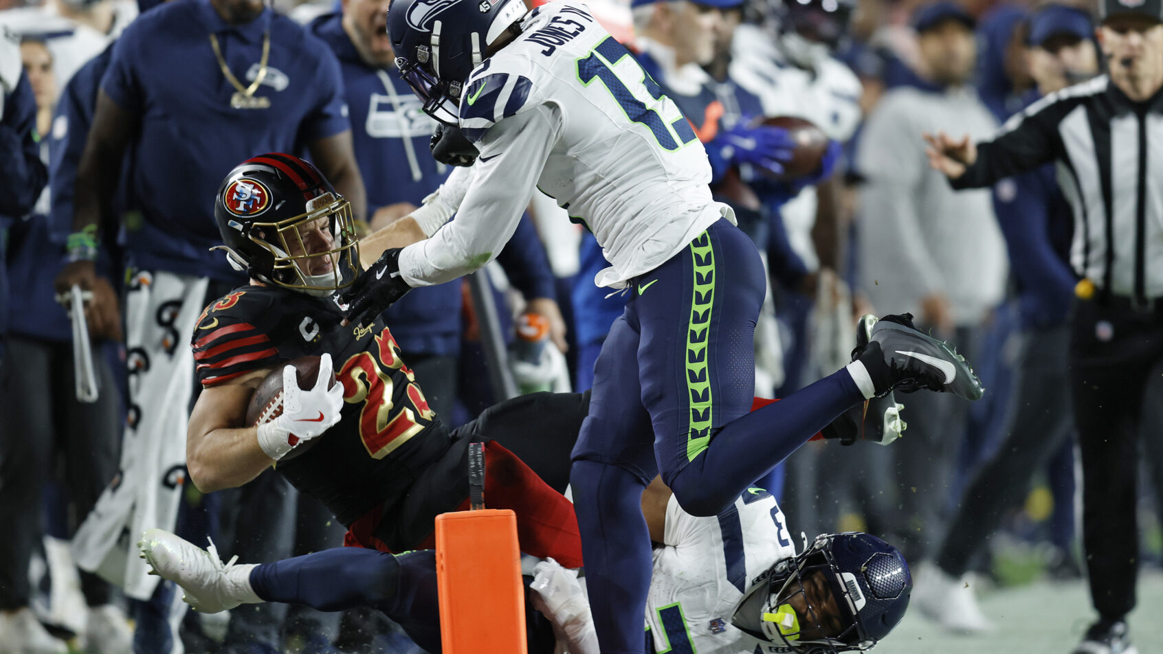 Christian McCaffrey being hit out of bounds