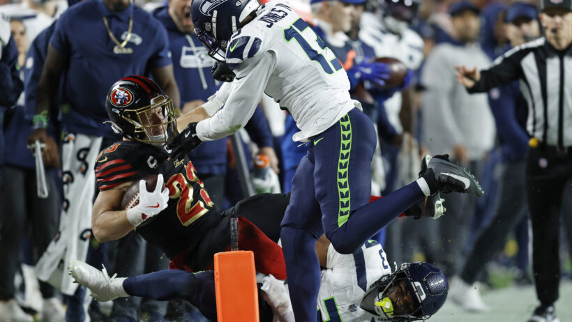 Christian McCaffrey being hit out of bounds