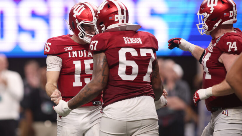 Fernando Mendoza celebrates with his teammates.