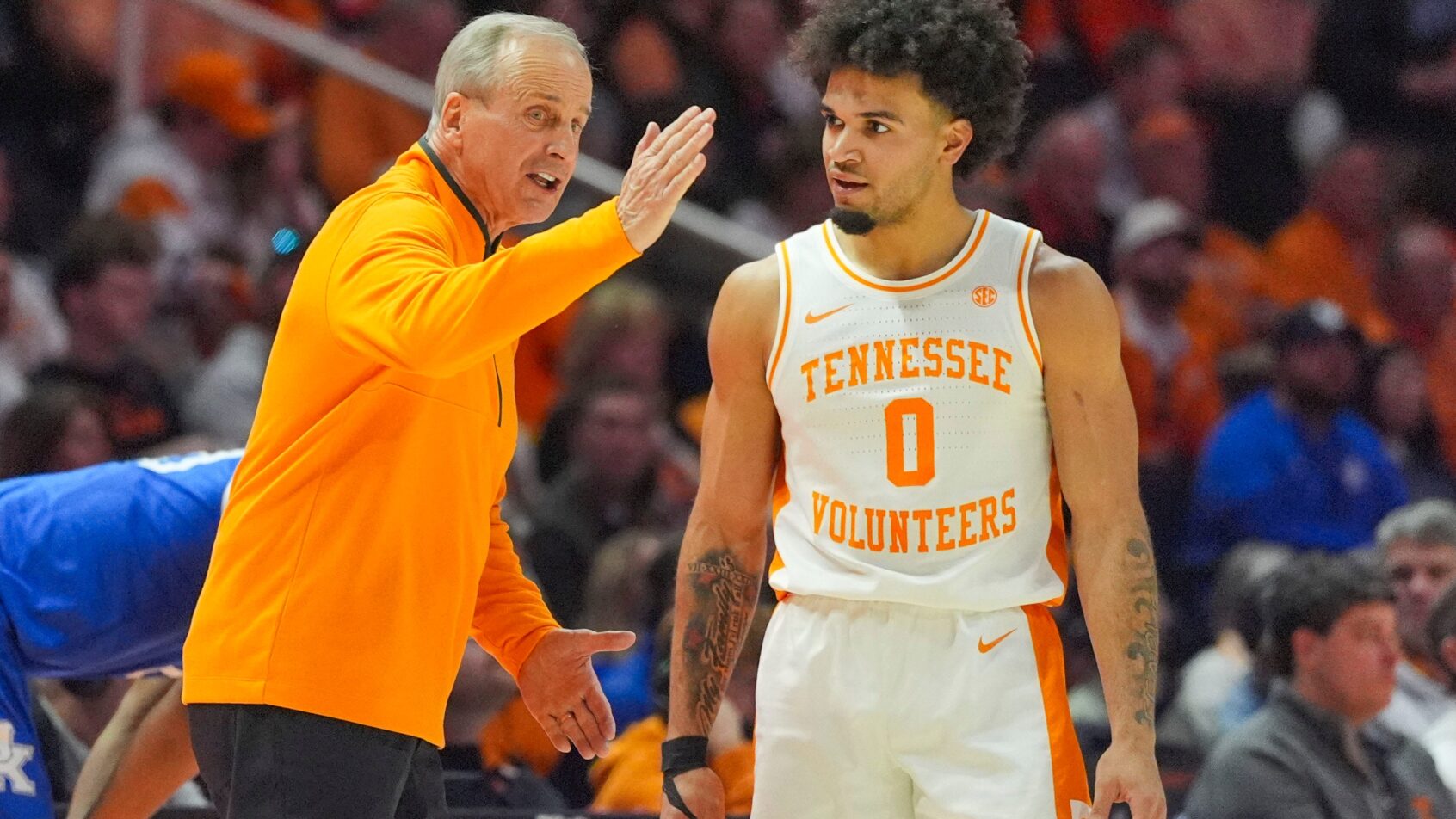 Ja'Kobi Gillespie and Rick Barnes discuss strategy during a Tennessee timeout.