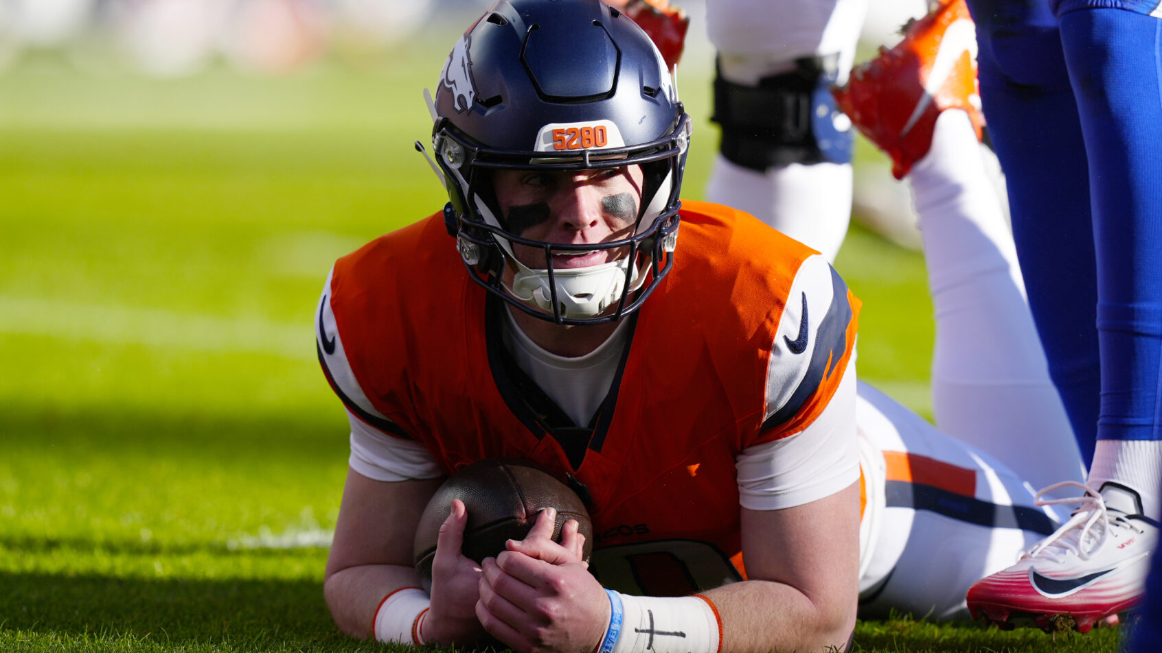 Denver Broncos quarterback Bo Nix on the ground
