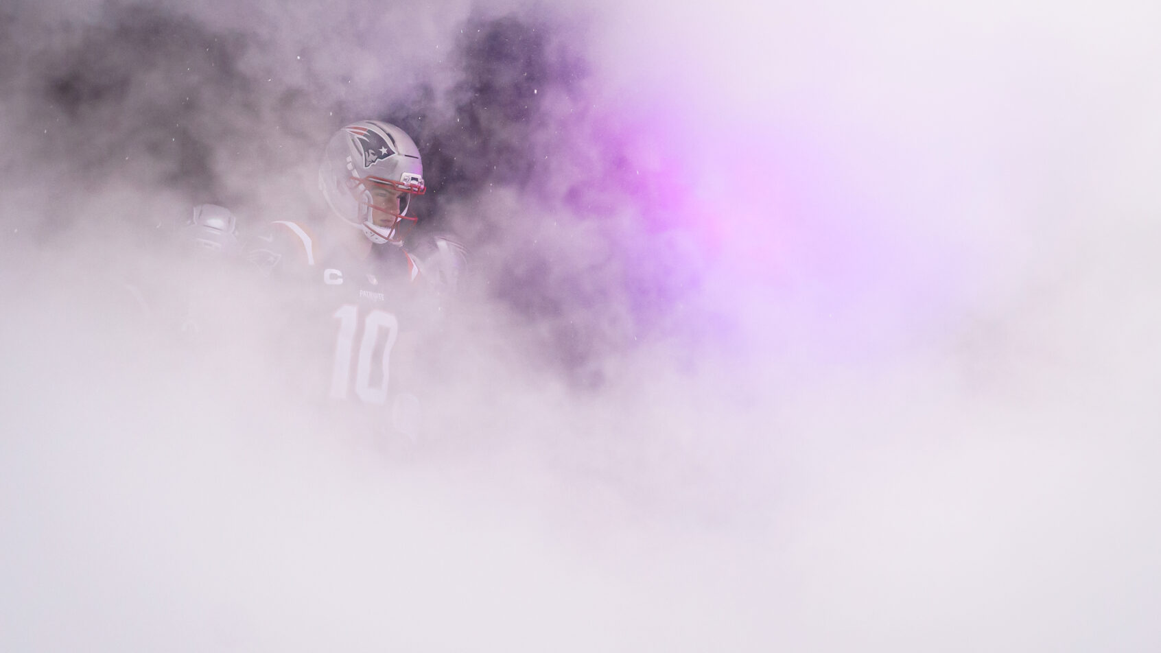 New England Patriots quarterback Drake Maye walking onto the field