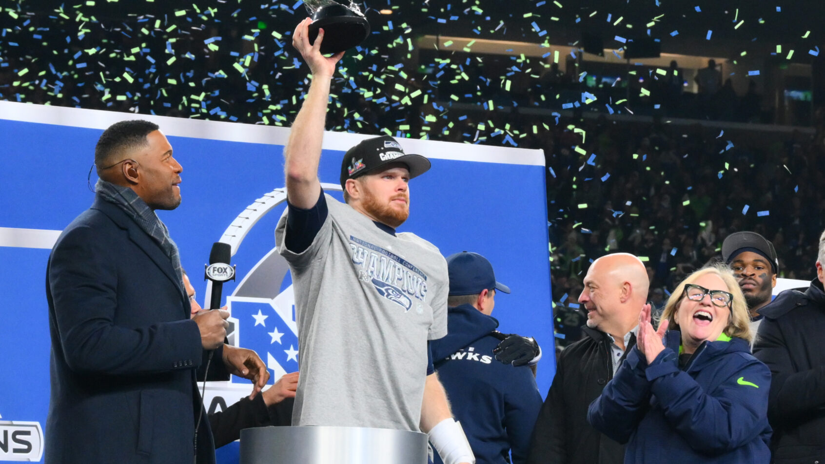 Seattle Seahawks quarterback Sam Darnold lifts the NFC Championship Trophy