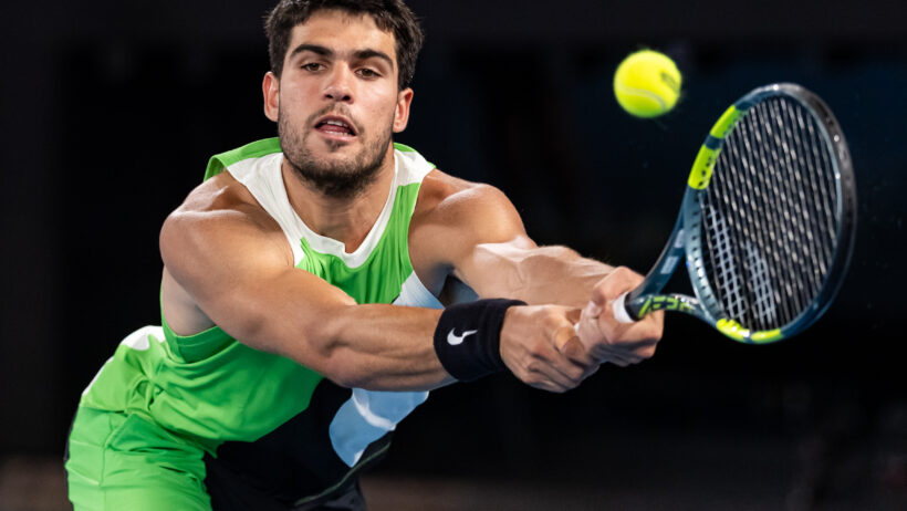 Carlos Alcaraz stretches to hit a backhand