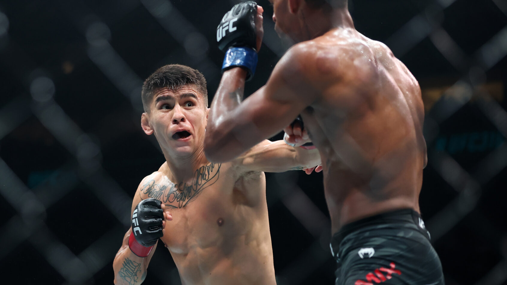 Mario Bautista throws a punch at Patchy Mix during a UFC 316 bout.