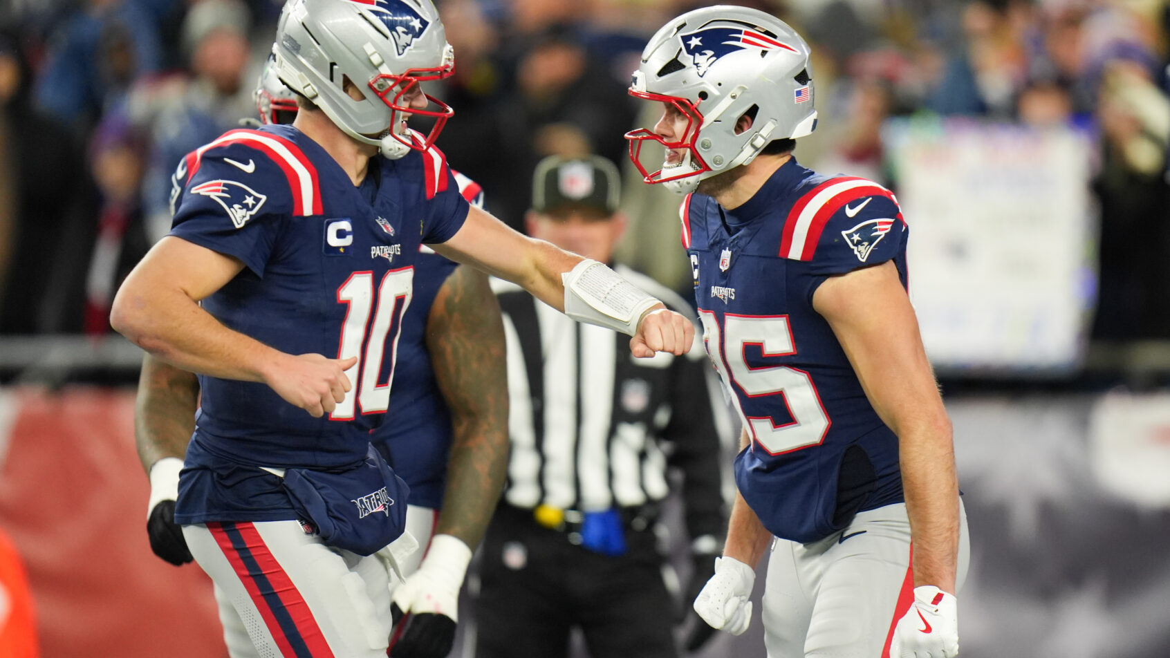 New England Patriots tight end Hunter Henry celebrates with QB Drake Maye