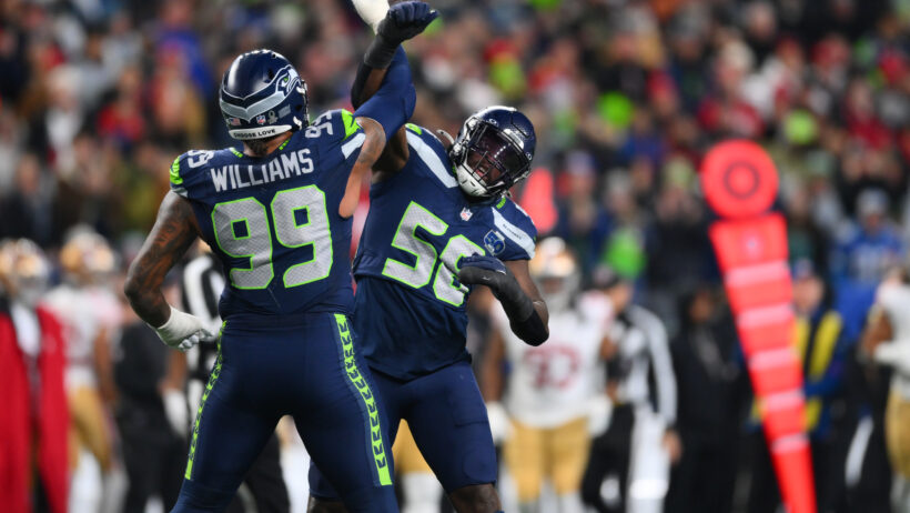 Seattle Seahawks defensive end Leonard Williams and linebacker Derick Hall celebrate a sack