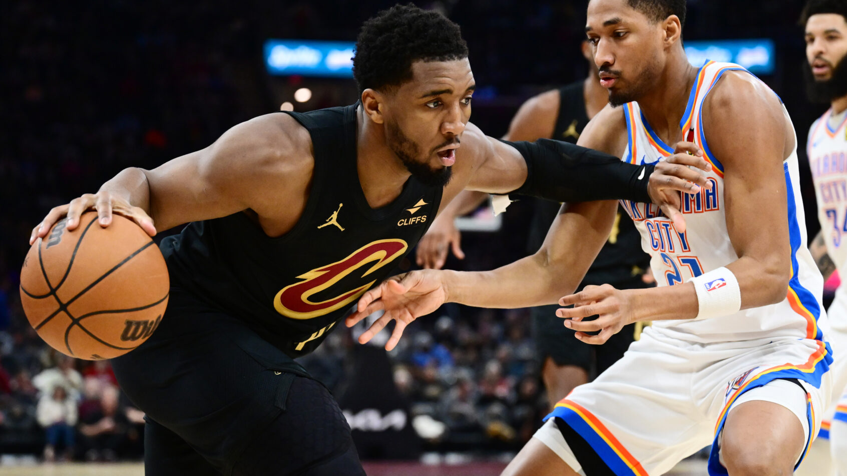 Cleveland Cavaliers guard Donovan Mitchell drives at Oklahoma City Thunder guard Aaron Wiggins