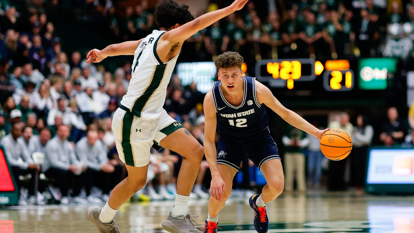 Utah State Aggies guard Mason Falslev dribbling