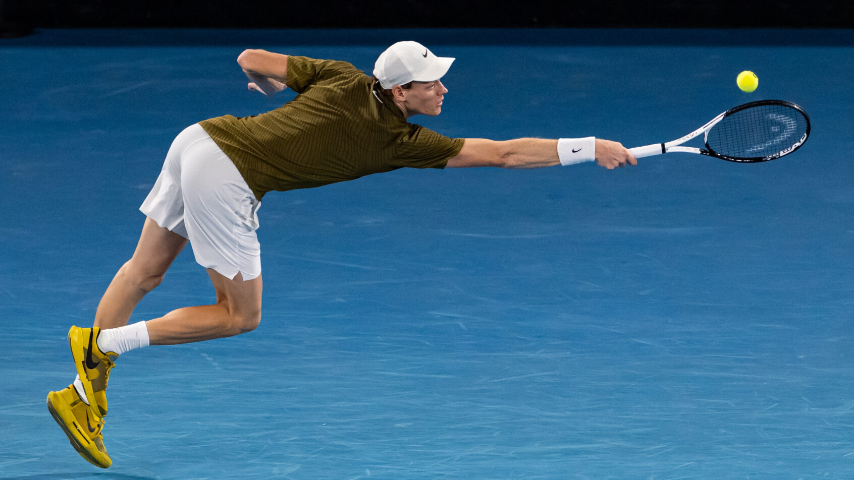 Jannik Sinner stretches to hit a backhand