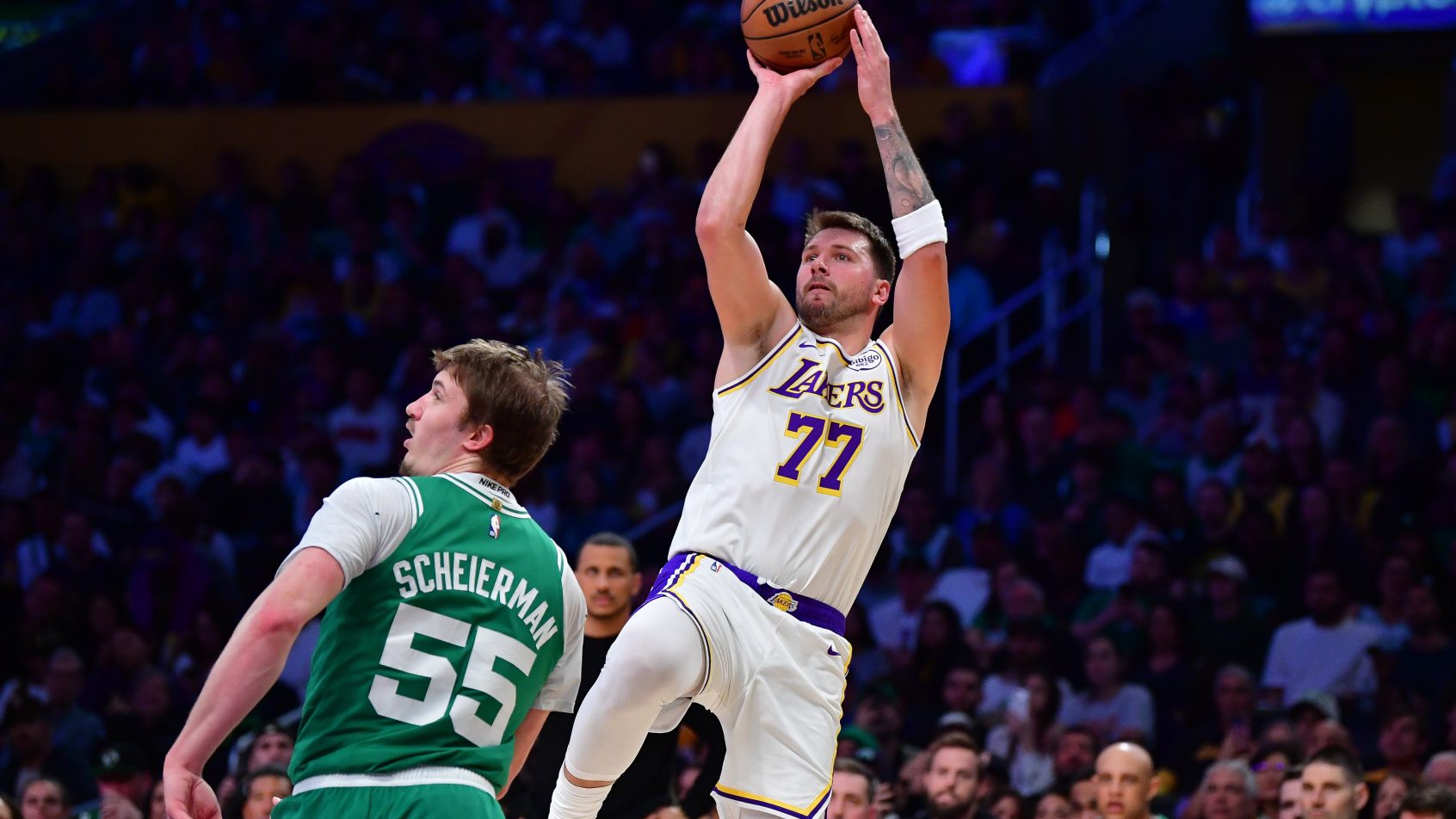 Luka Doncic (77) shoots against Boston Celtics guard Baylor Scheierman