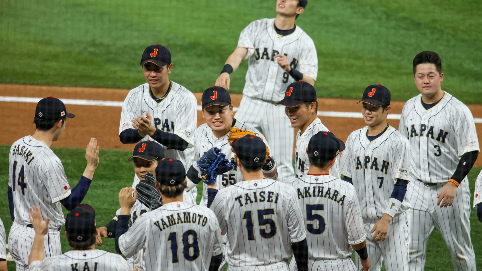 Team Japan celebrates a win at the WBC