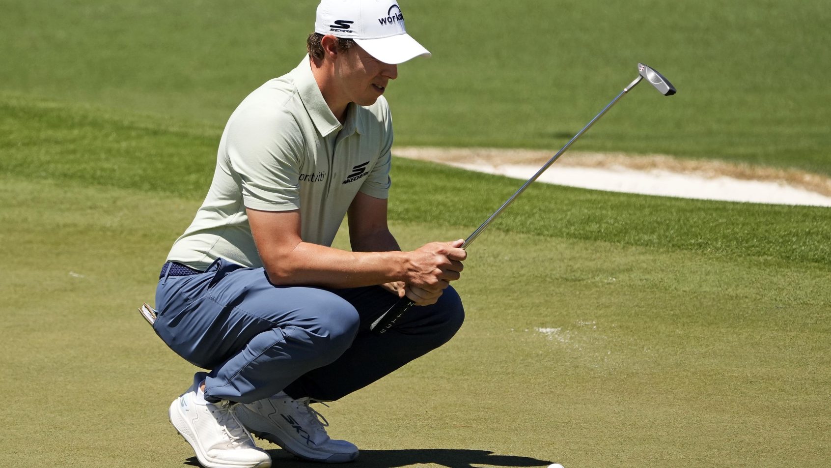 Matthew Fitzpatrick sizes up a putt at the 2024 Masters.