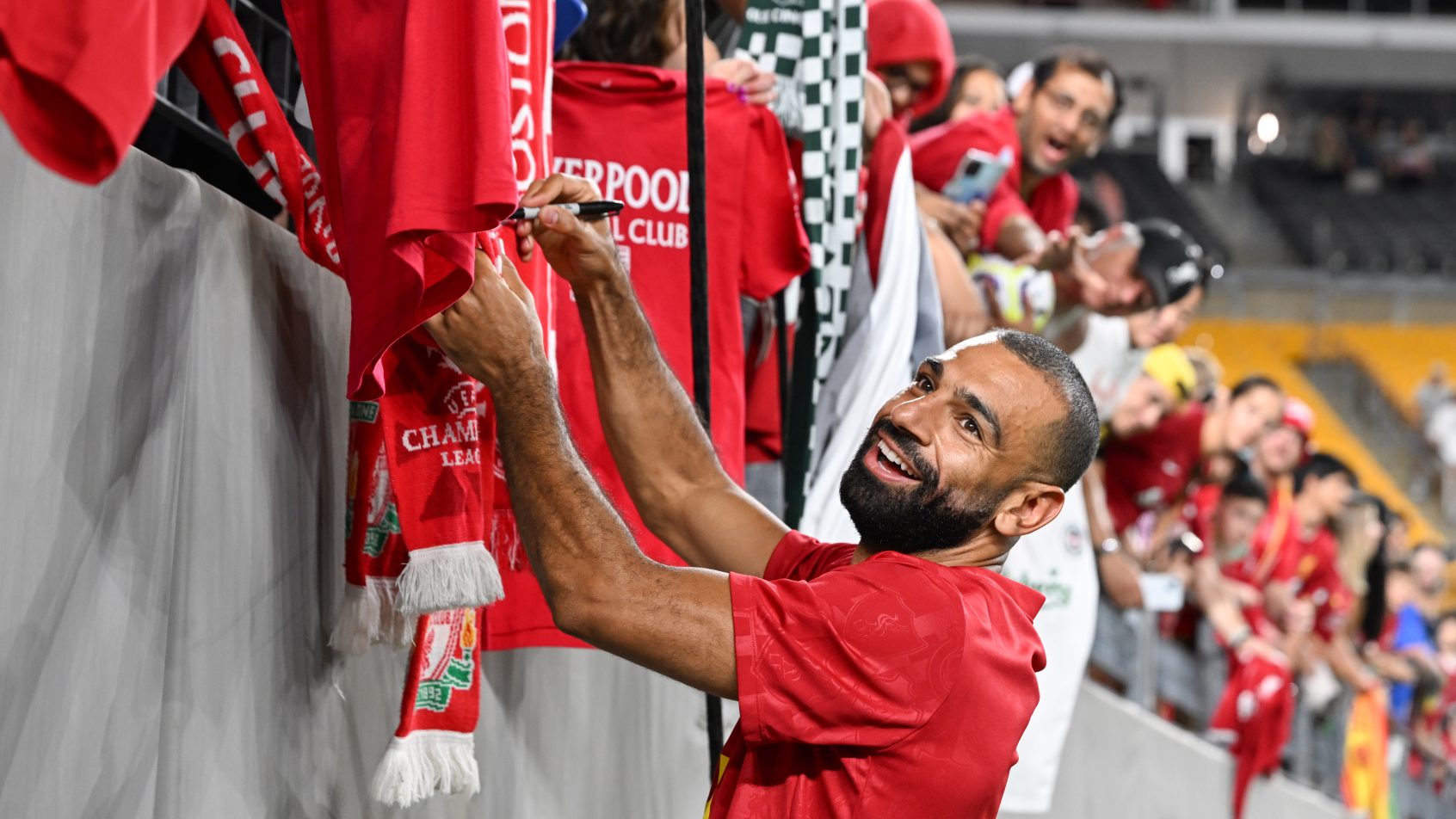 Liverpool forward Mohamed Salah greets fans