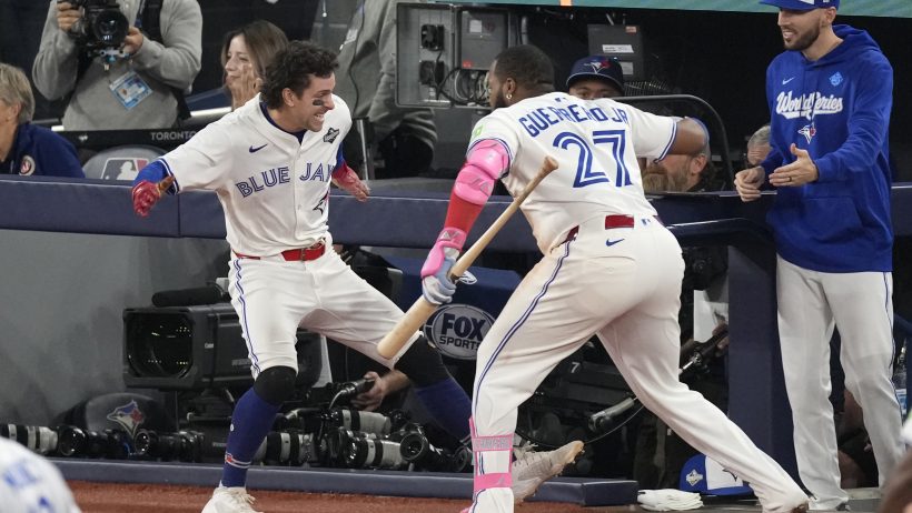 Ernie Clement and Vladimir Guerrero Jr celebrate a Blue Jays run vs the Dodgers.