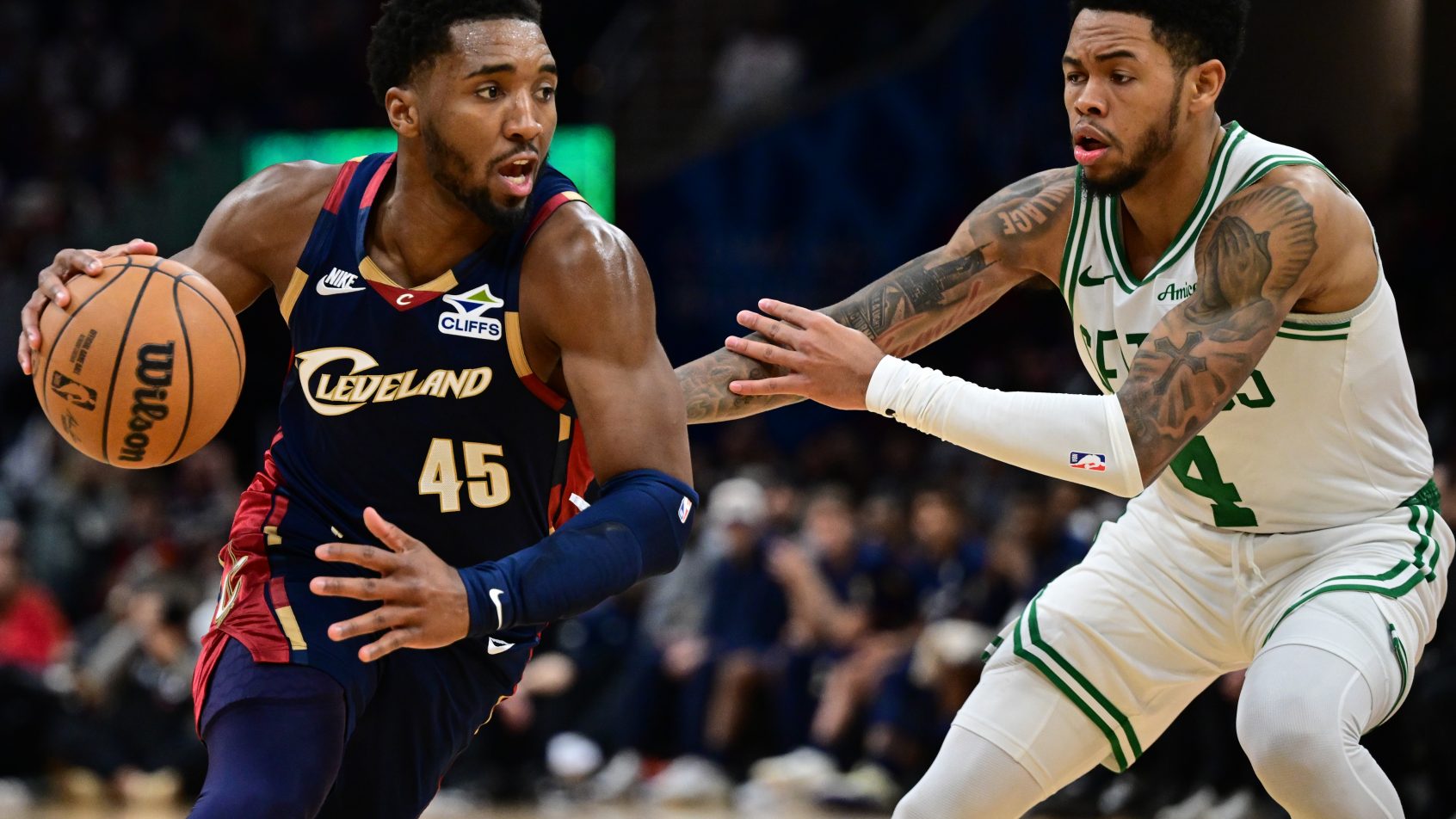 Cleveland Cavaliers guard Donovan Mitchell drives around Boston Celtics guard Anfernee Simons