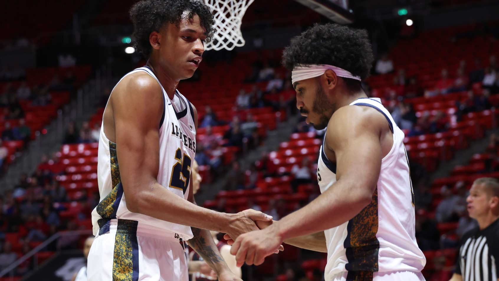 California Baptist Lancers forward Thomas Ndong (25) and guard Dominique Daniels Jr. (1) shake hands