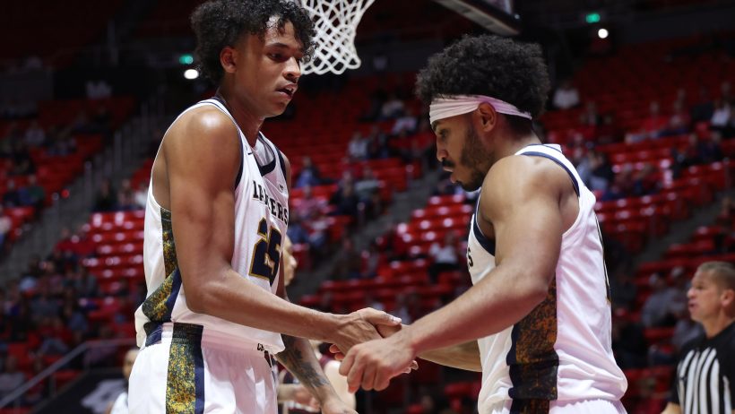 California Baptist Lancers forward Thomas Ndong (25) and guard Dominique Daniels Jr. (1) shake hands