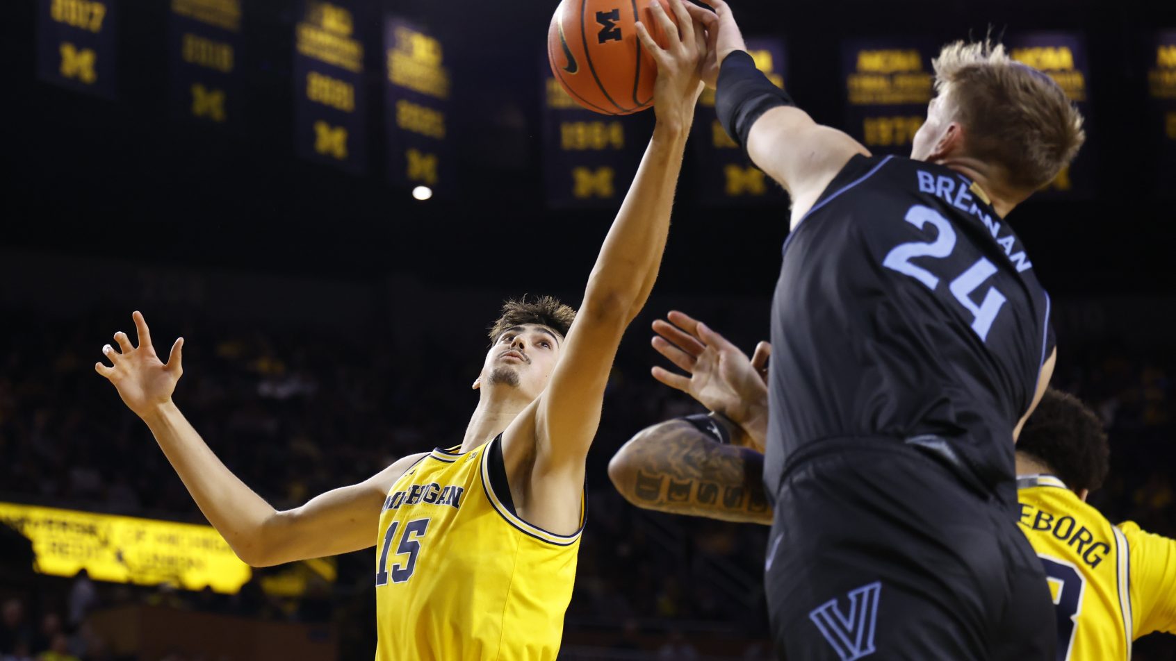 Michigan Wolverines center Aday Mara and Villanova Wildcats forward Duke Brennan go for a rebound