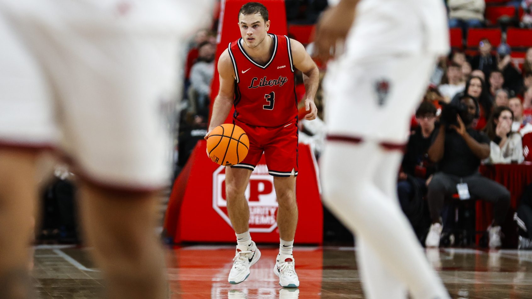 Liberty Flames guard Kaden Metheny brings the ball up the court