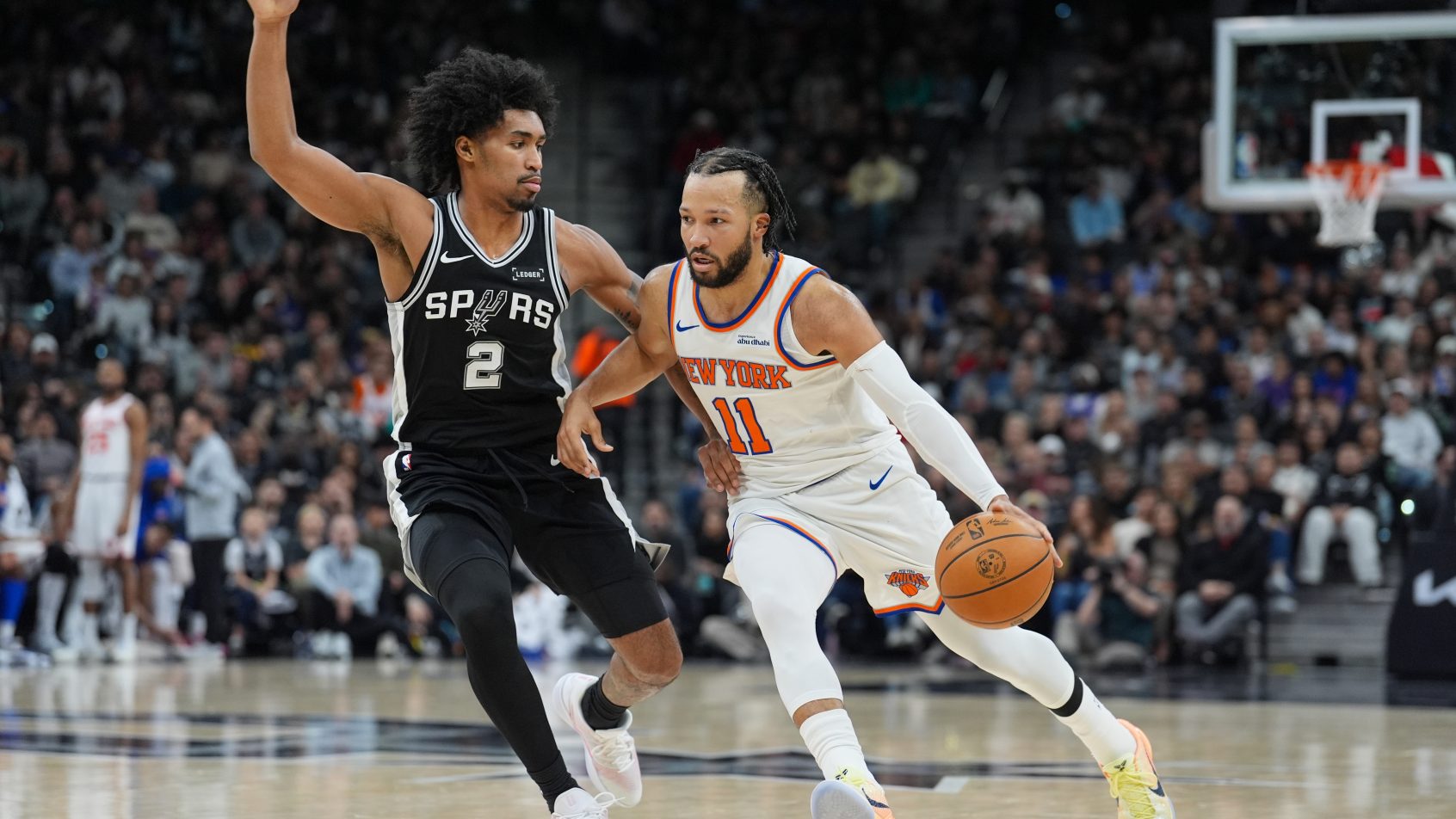 New York Knicks guard Jalen Brunson drives around San Antonio Spurs guard Dylan Harper