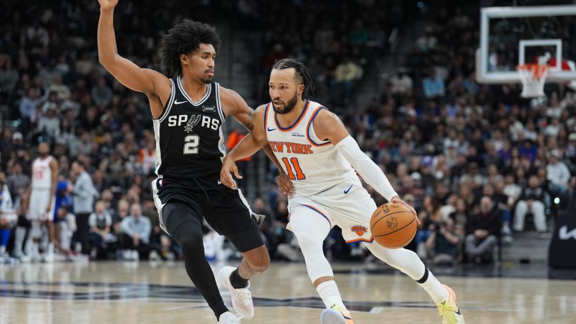 New York Knicks guard Jalen Brunson drives around San Antonio Spurs guard Dylan Harper
