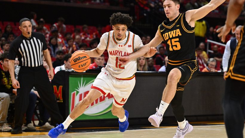 Maryland Terrapins guard Isaiah Watts dribbles around Iowa Hawkeyes guard Brendan Hausen