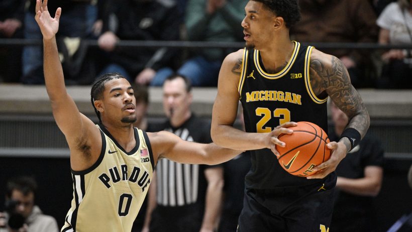 Purdue Boilermakers guard C.j Cox defending Michigan Wolverines forward Yaxel Lendeborg