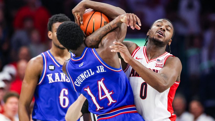 Arizona Wildcats guard Jaden Bradley and Kansas Jayhawks guard Melvin Council Jr battle for the ball