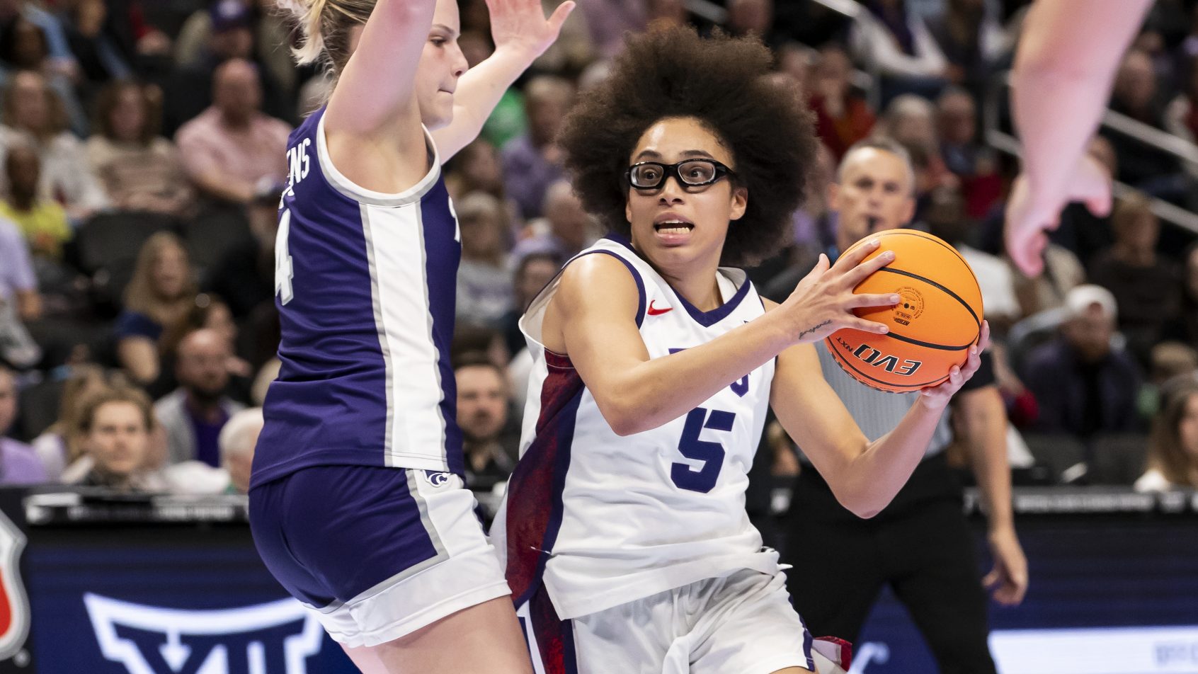 TCU's Olivia Miles drives to the hoop versus a Kansas State defender.