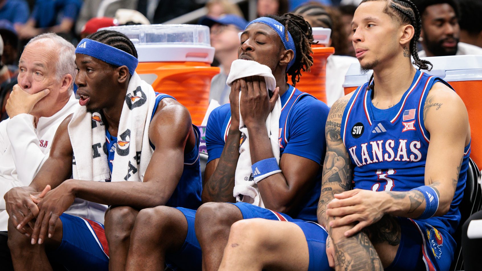 Kansas Jayhawks players look dejected on the bench