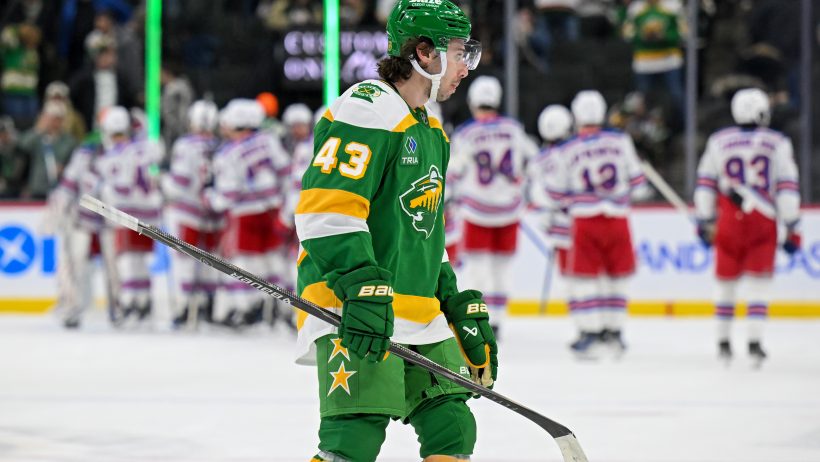 Quinn Hughes looks on during a stoppage in play versus the Rangers.