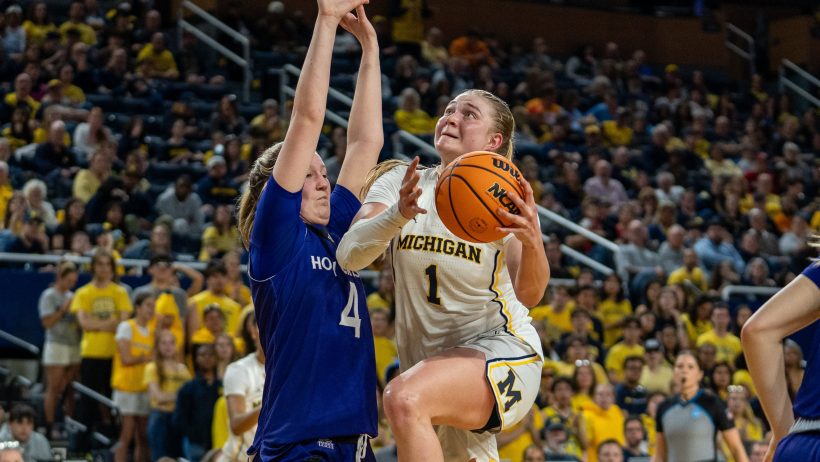 Olivia Olson driving against defender