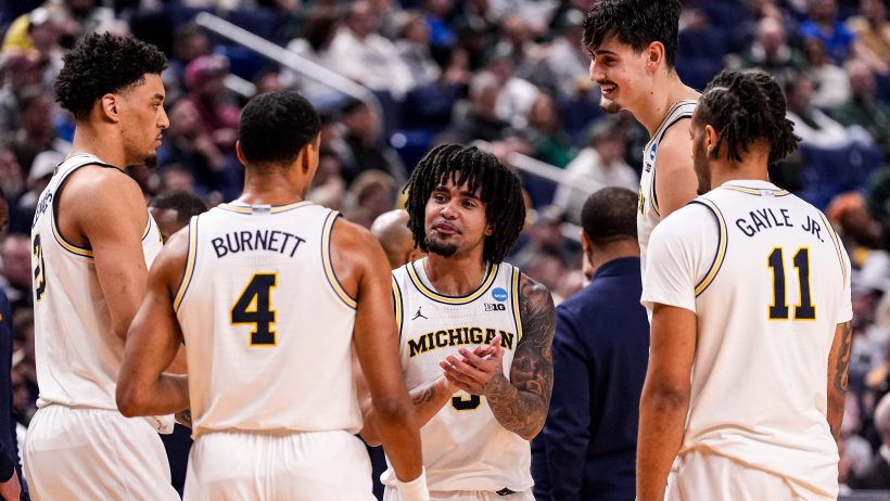 Michigan players huddling on the court
