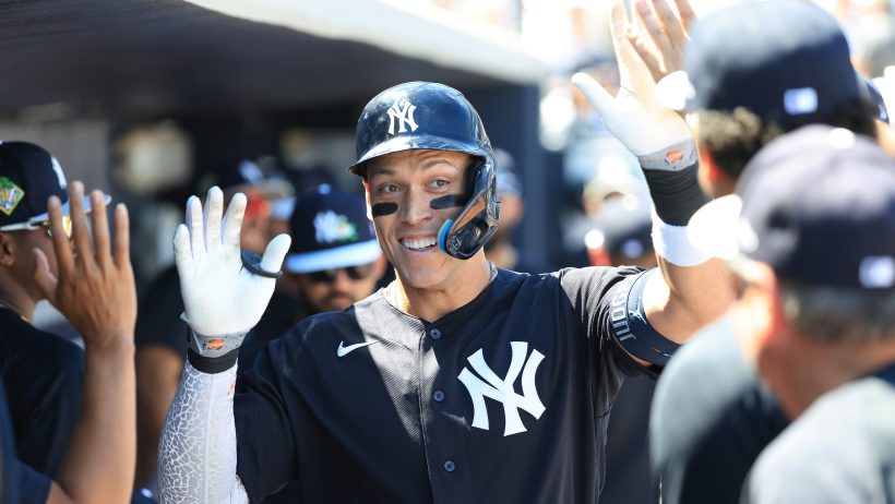 Aaron Judge high-fives with teammates following a Spring Training home run versus the Phillies.