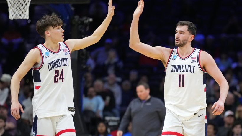 UConn Huskies forward Alex Karaban high-fiving guard Braylon Mullins