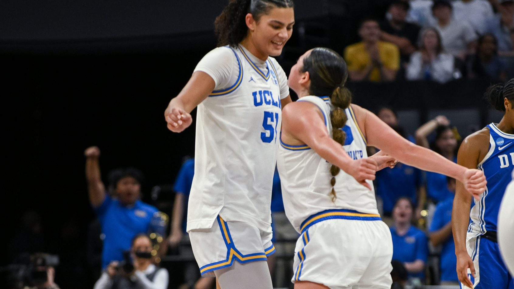 UCLA Bruins center Lauren Betts chest bumping guard Charlisse Leger-Walker