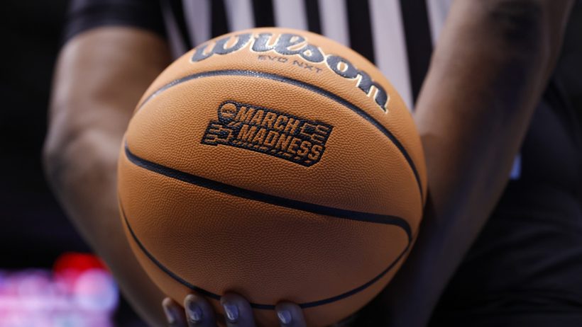 Existing user promos for March Madness. Ref holding a basketball.