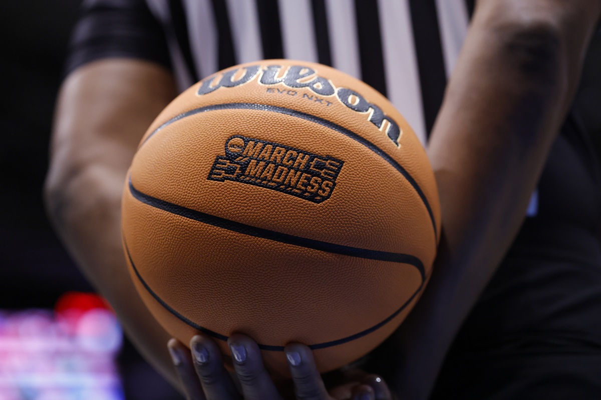 Existing user promos for March Madness. Ref holding a basketball.