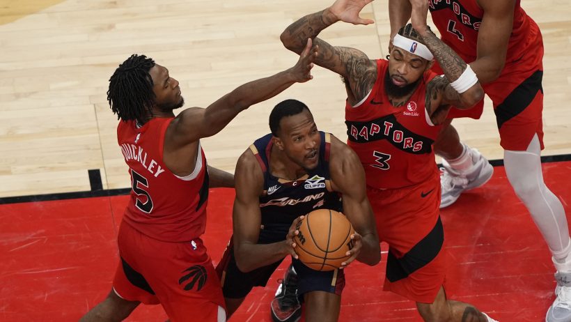 Immanuel Quickley and Brandon Ingram defend against Cleveland Cavaliers forward Evan Mobley