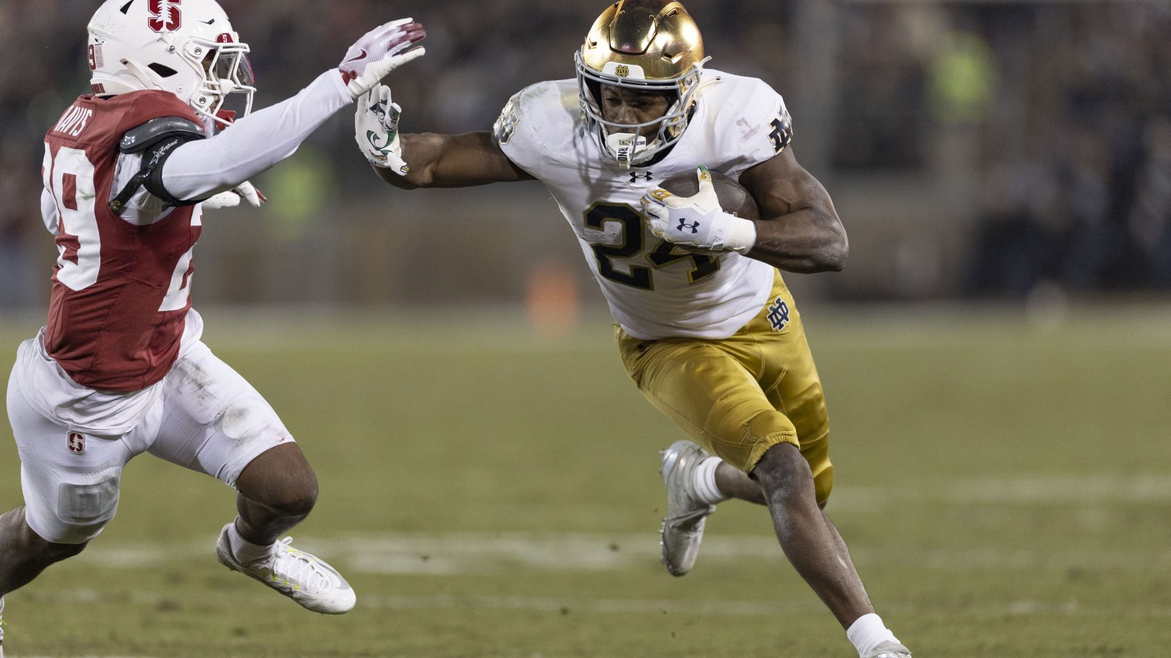 Jadarian Price fights off a Stanford tackle.
