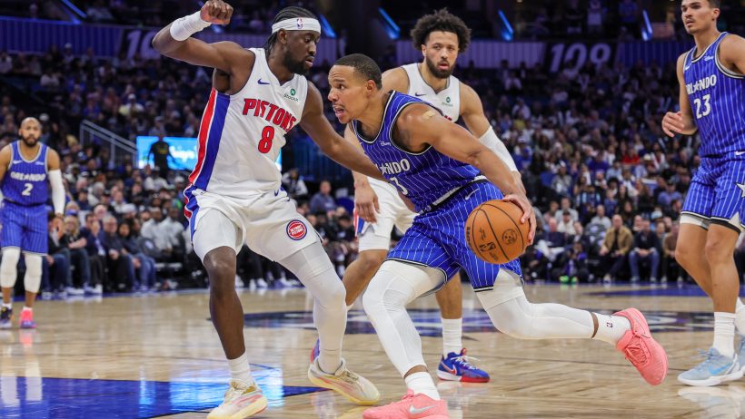 Desmond Bane drives around Detroit Pistons guard Caris LeVer