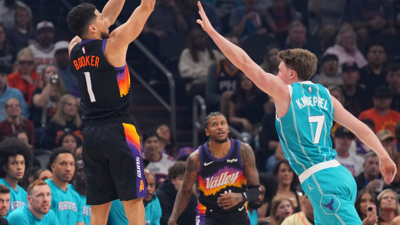 Devin Booker shoots over Charlotte Hornets guard Kon Knueppel