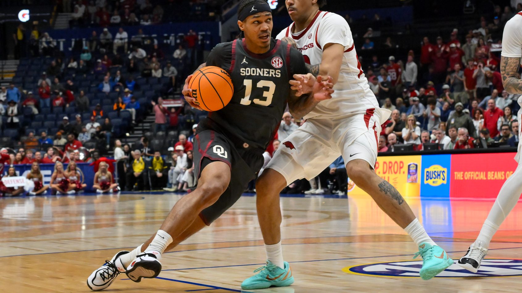 Sooners forward Tae Tavis drives to the hoop versus Arkansas.