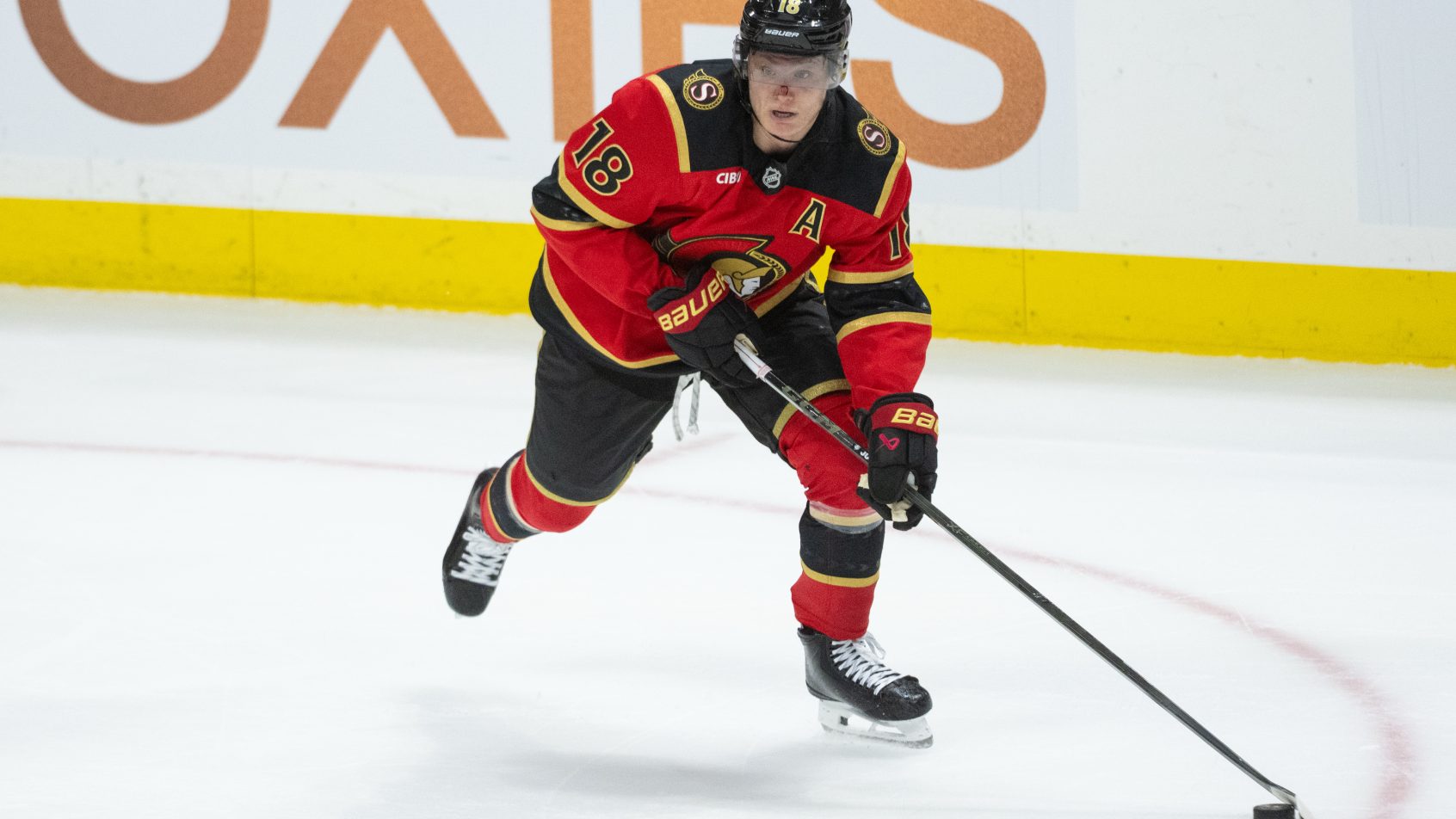 Tim Stutzle carries the puck inside the Penguins zone.