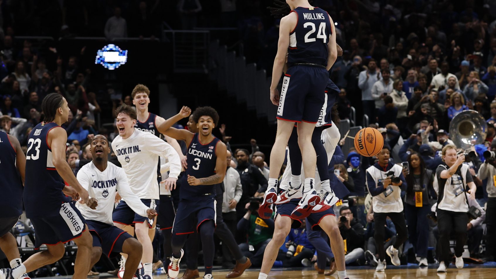 UConn Huskies guard Braylon Mullins congratulated by teammates