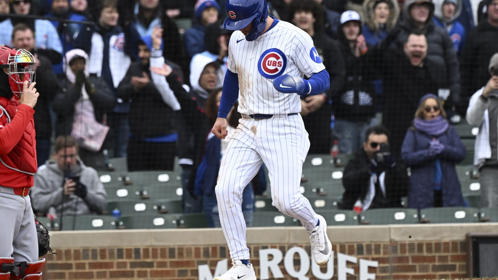 Nico Hoerner crosses the plate for the Cubs in a game versus the Angels.
