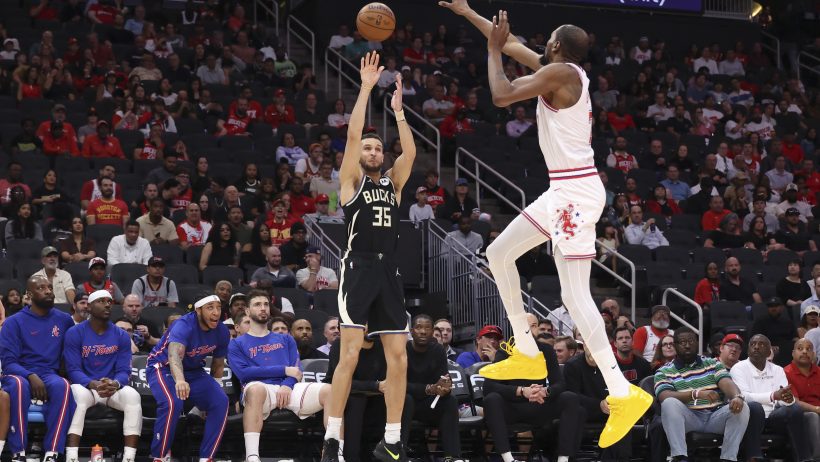 Milwaukee Bucks forward Pete Nance shoots the ball as Houston Rockets forward Kevin Durant defends.