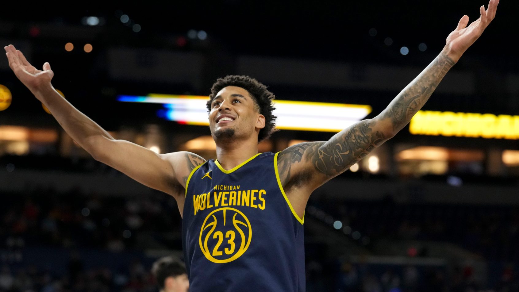 Michigan Wolverines forward Yaxel Lendeborg gestures to the stands during practice