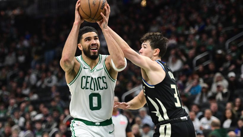 Jayson Tatum battles against Cormac Ryan during a Celtics vs Bucks game.